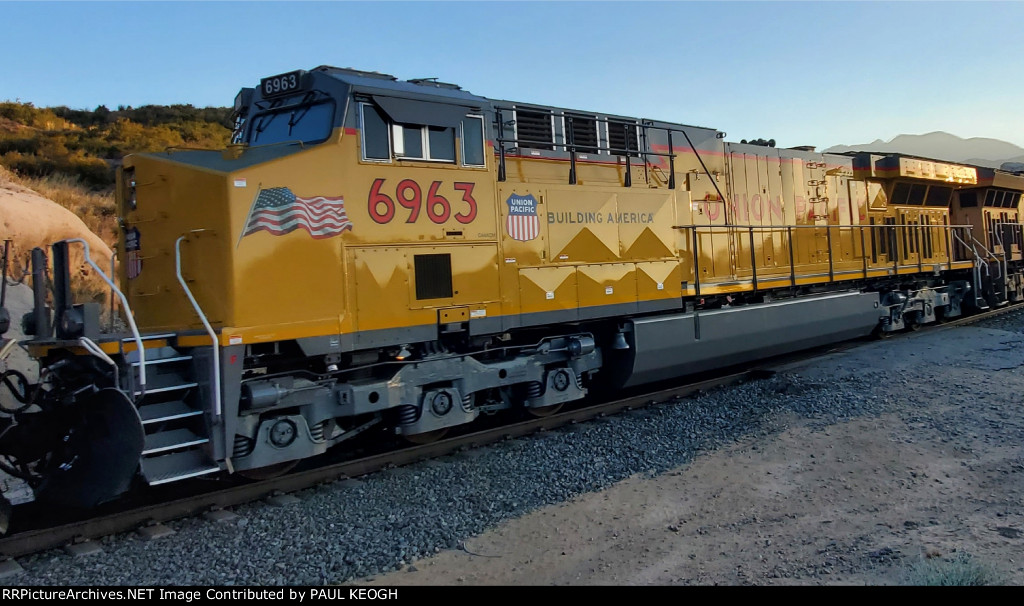 The California Setting Sun Reflects Off The Brand New UP Paint Scheme on A Brand New UP 6963 C44ACM as She Decend Cajon Pass on The UP Palmdale Cutoff at the South Canyon Siding 